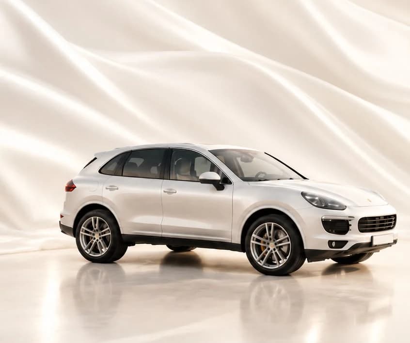 A white luxury vehicle on warm ivory silk — imported from Canada to Saudi Arabia